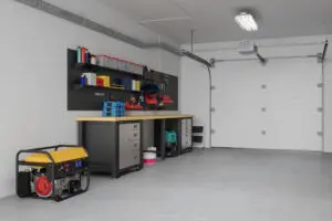 Organized garage workshop with tools, storage cabinets, and shelves neatly