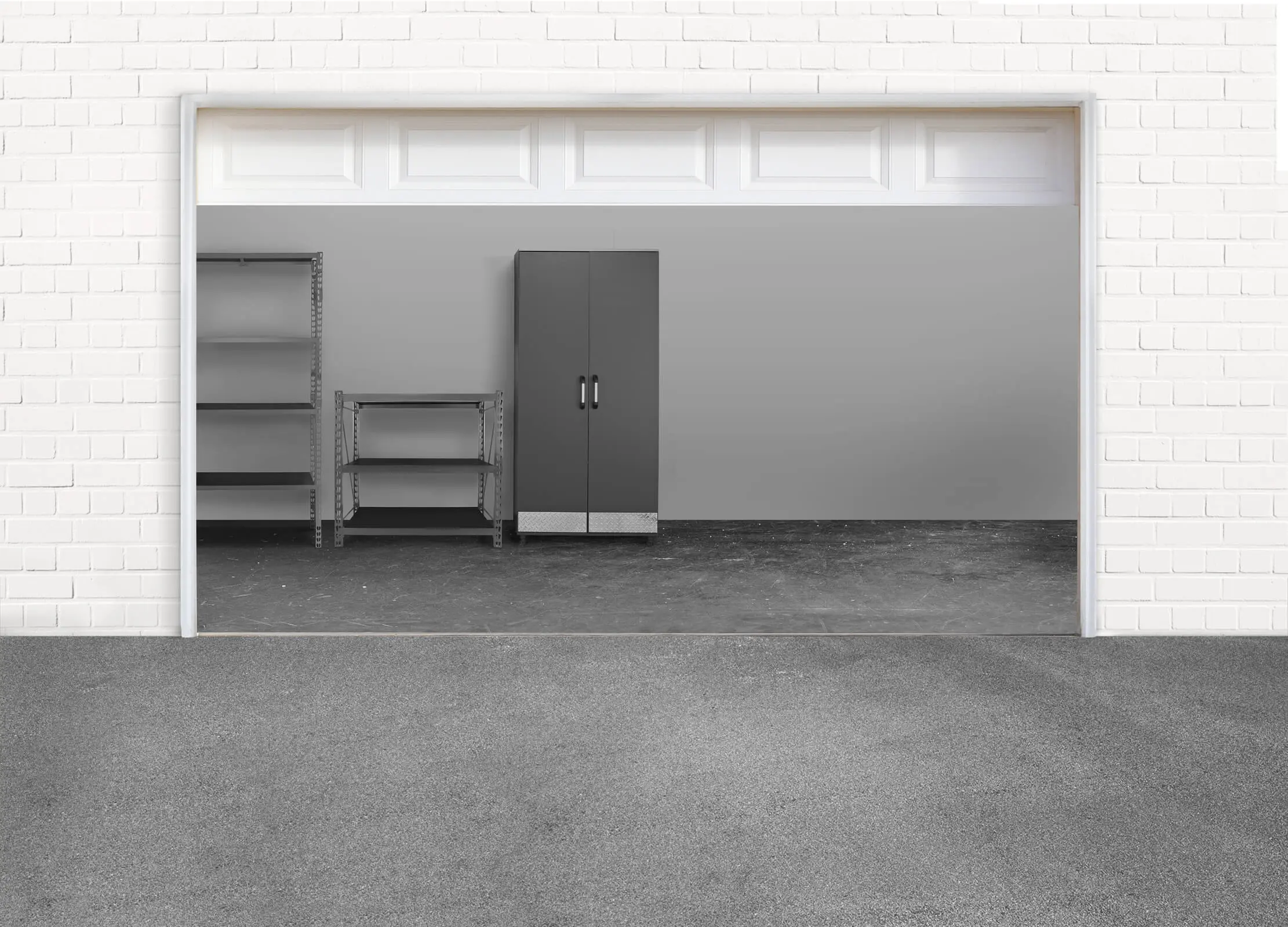 Empty garage with gray concrete floor, two empty shelves on the left