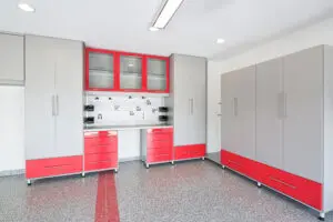 Modern kitchen with red and gray cabinets and a patterned backsplash in a bright